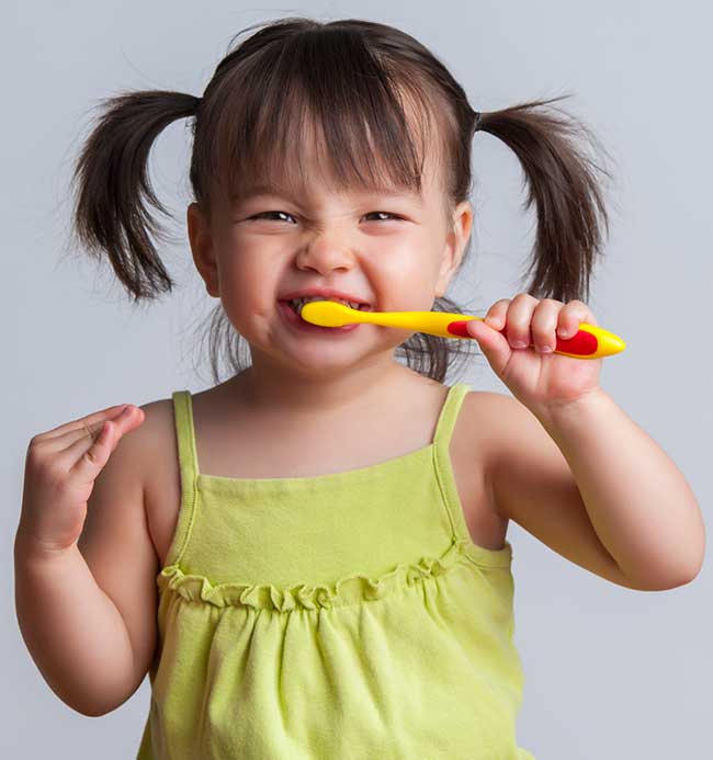 Little Girl is Brushing Her Teeth