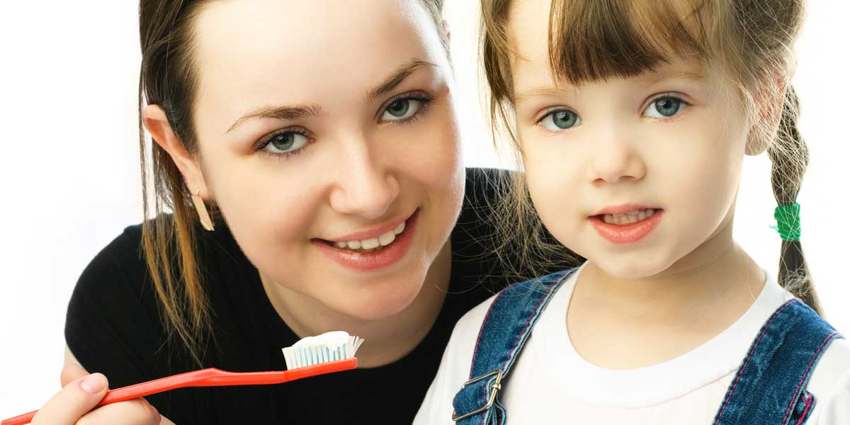 Mother and Daughter are Brushing Their Teeth